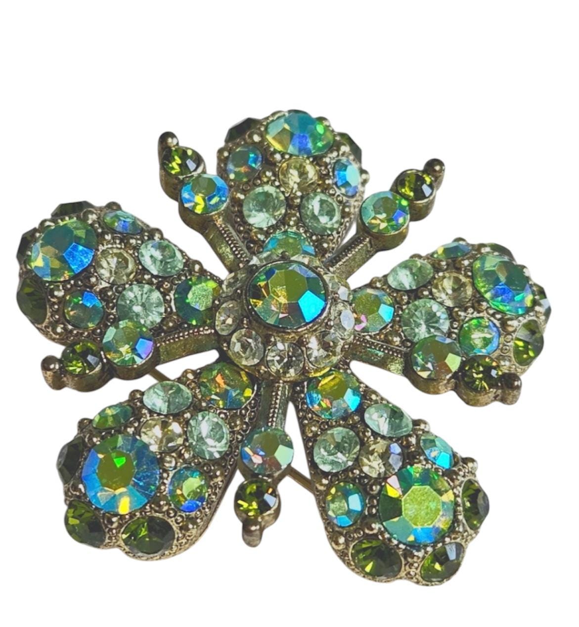 Joan Rivers Star Burst Brooch: Elegant Gold-Toned Accessory with Opalescent Green Crystals